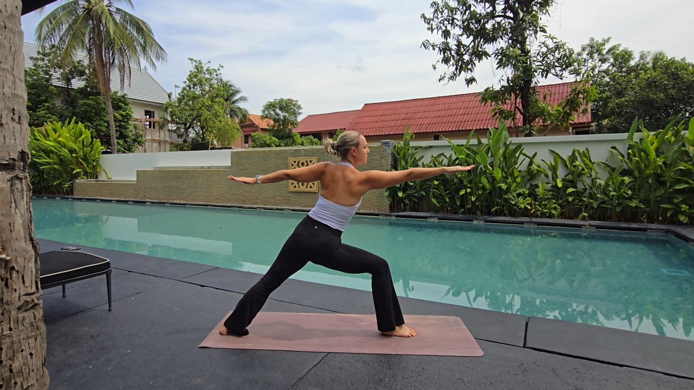 Jen practicing yoga on a rocky shoreline