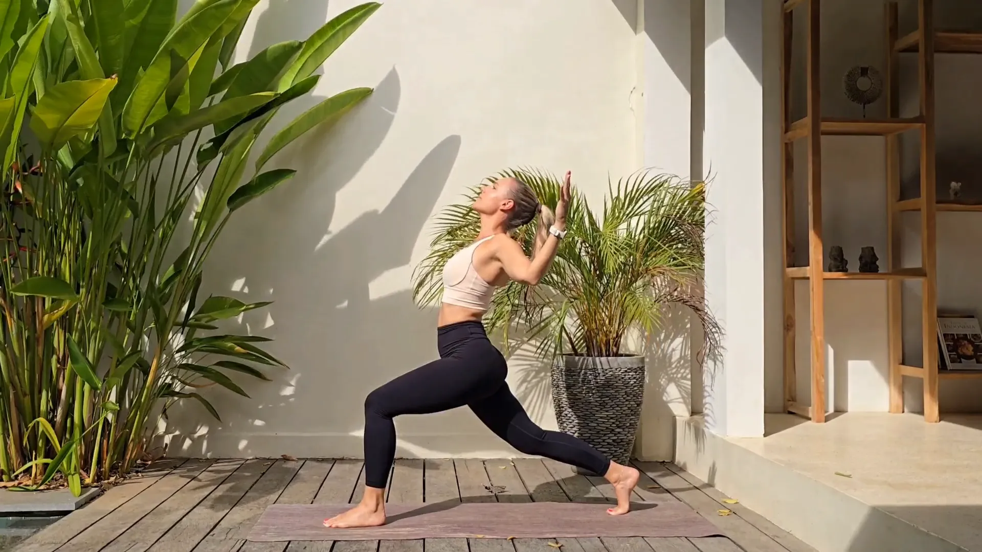 Jen practicing yoga on a rocky shoreline