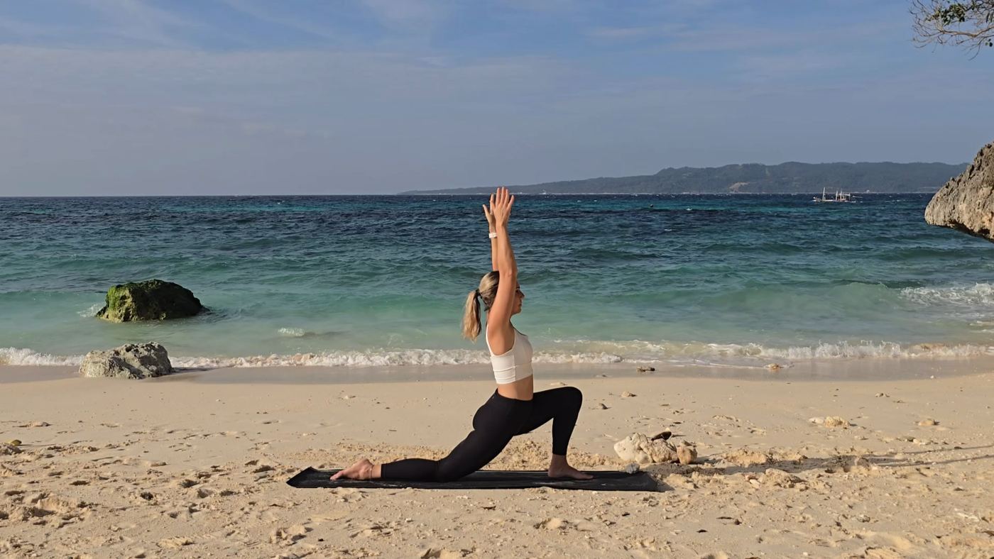 Jen practicing yoga on a beach