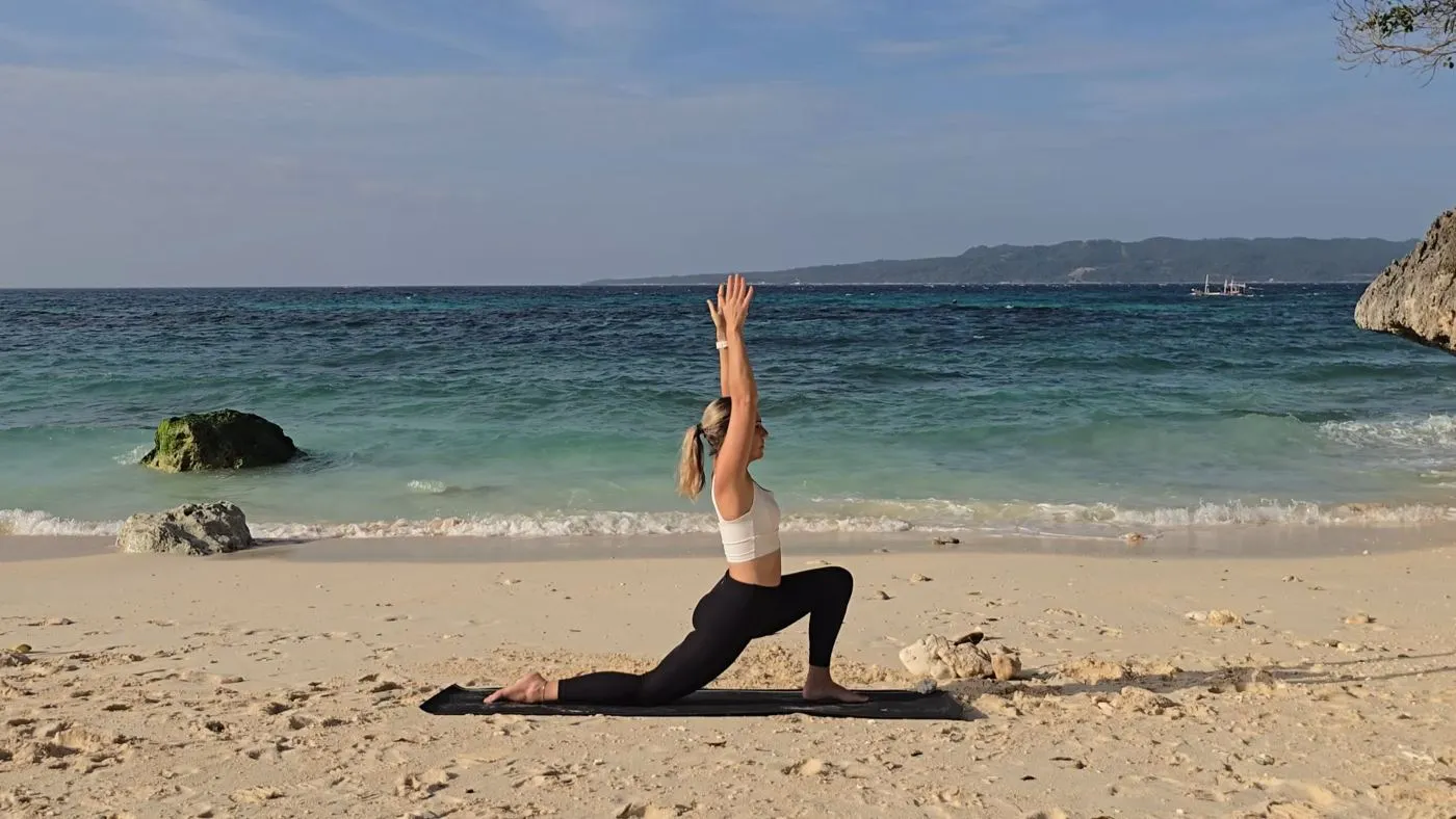 Jen practicing yoga on a beach