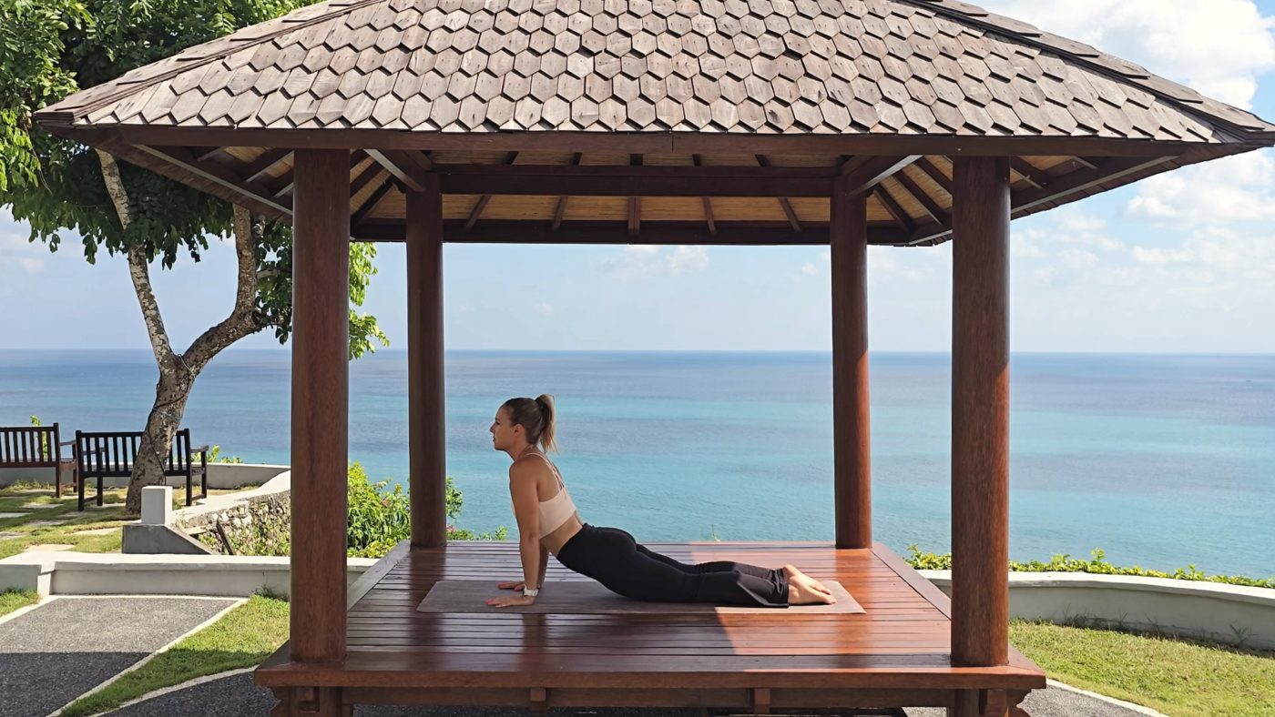 Jen in Cobra Pose on an ocean view gazebo deck