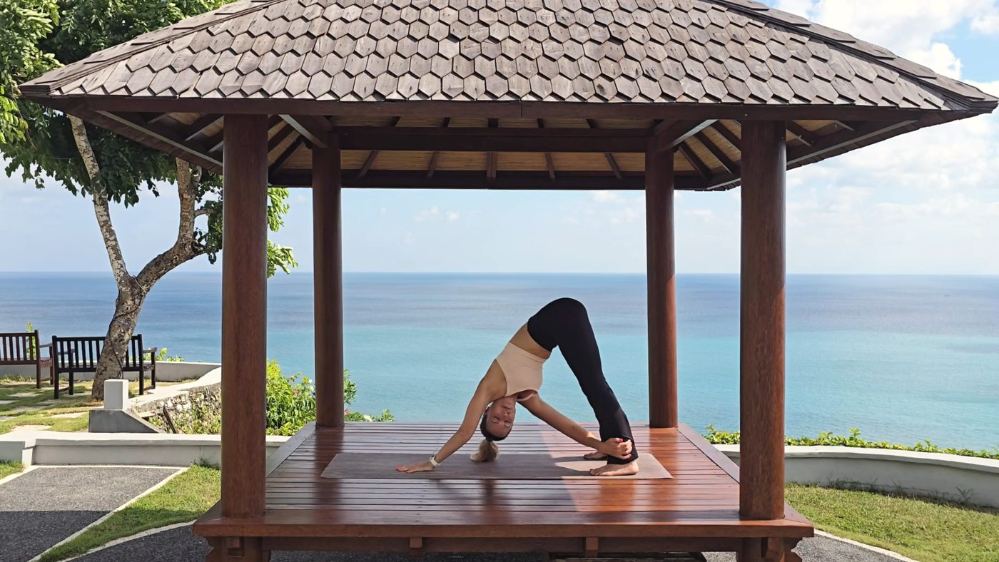 Jen in Downward Dog on an ocean view gazebo