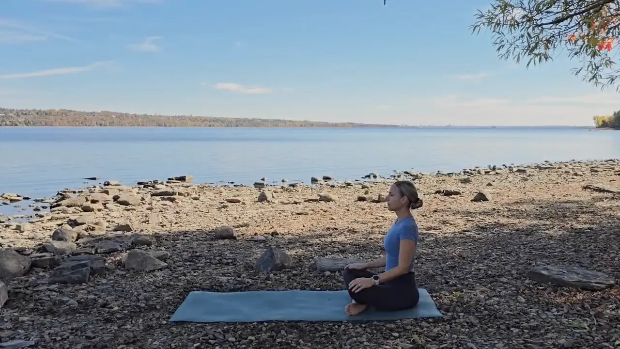 Jen seated in Easy Seat meditation by a fireplace