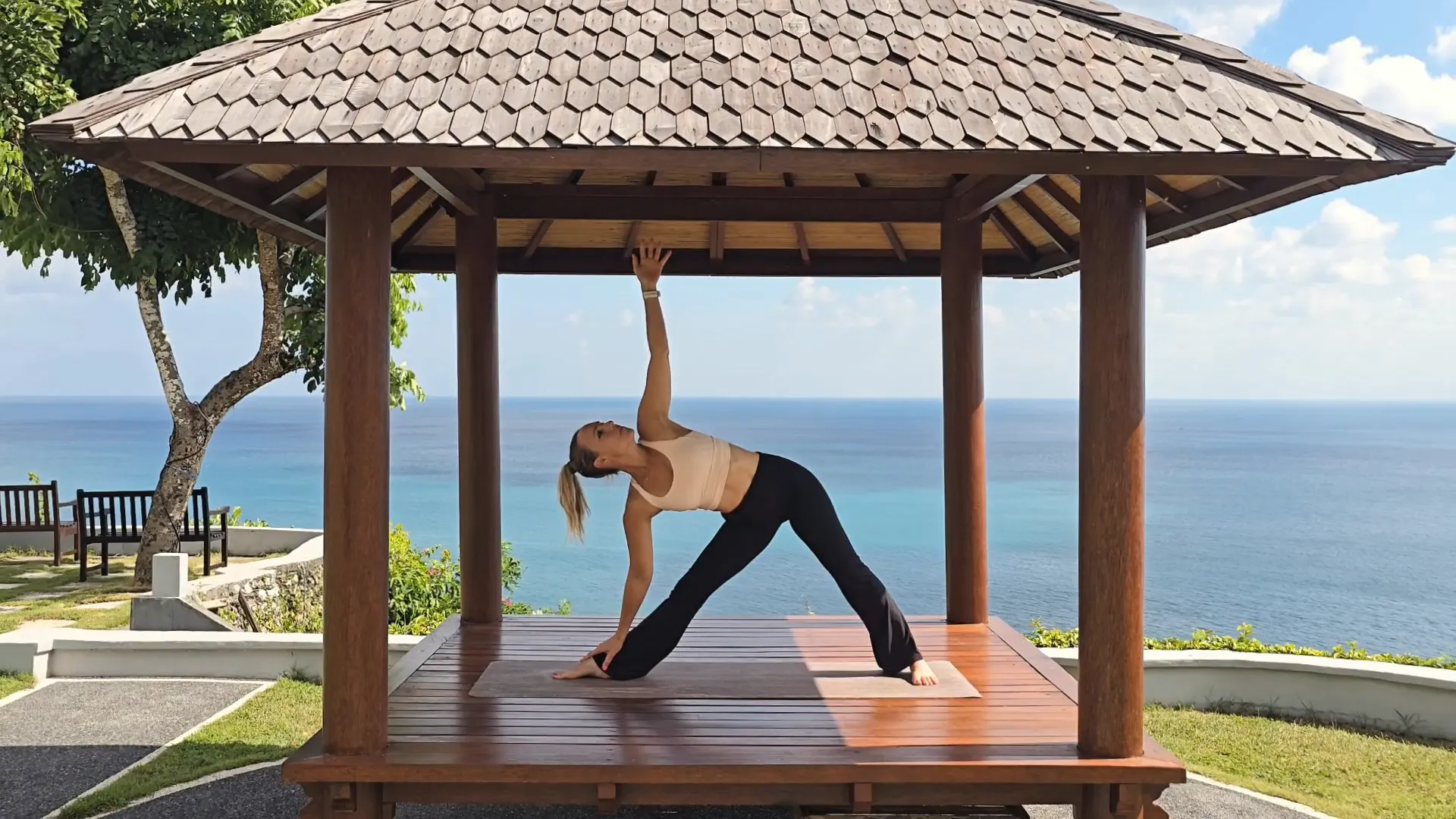 Jen in Triangle Pose on a mountain view terrace